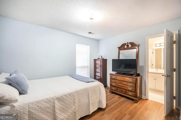 a bedroom with a bed and a flat screen tv