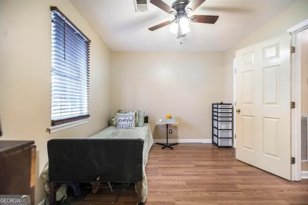 a bedroom with furniture and a window