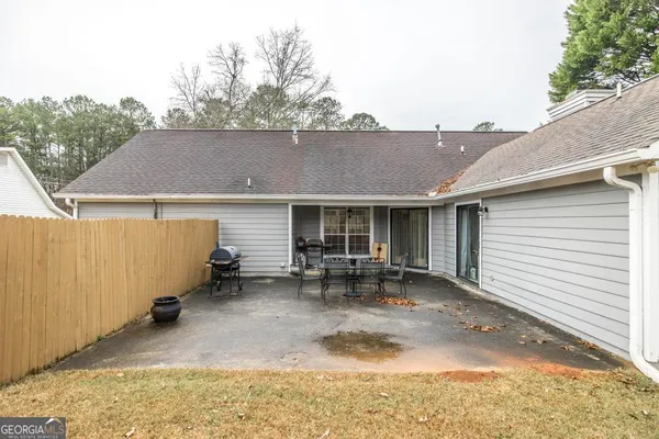 a view of house with backyard and outdoor seating
