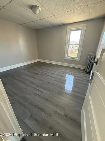 a view of an empty room and a window