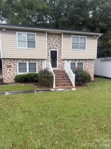 a view of backyard of house with green space
