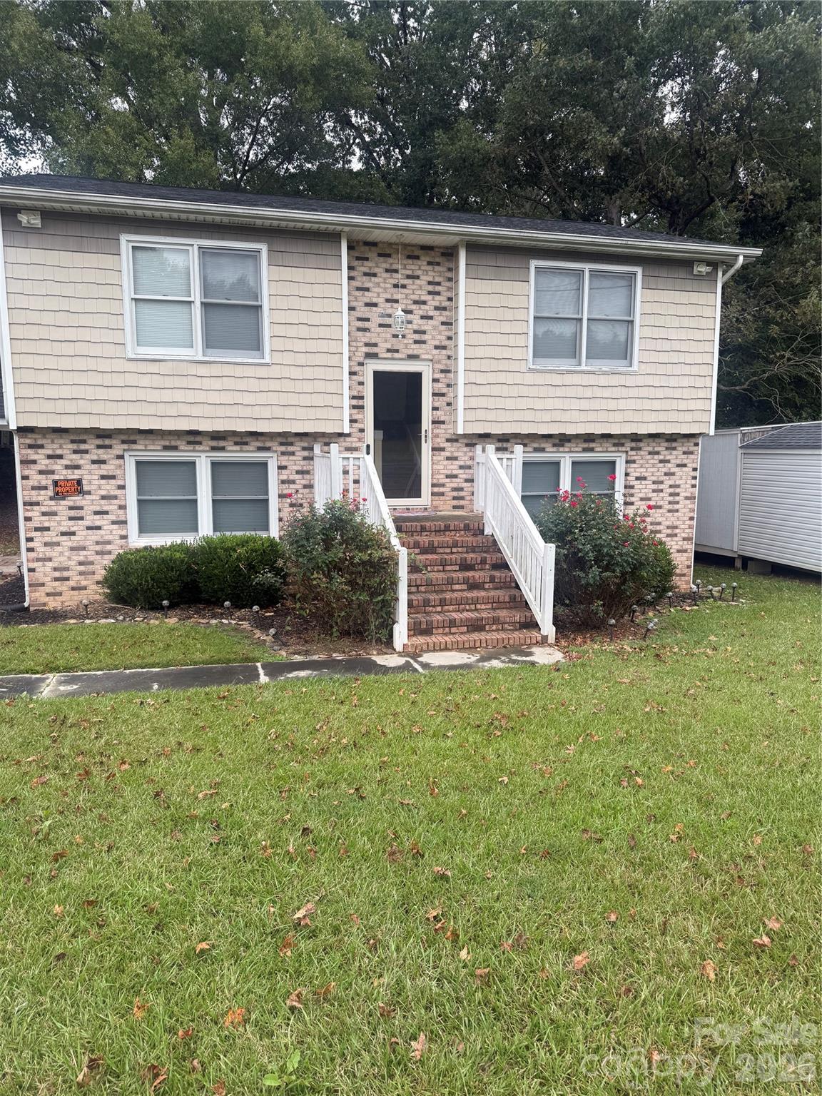 a view of backyard of house with green space