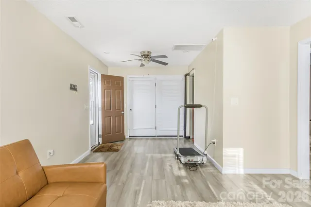 a view of a livingroom with furniture and a ceiling fan