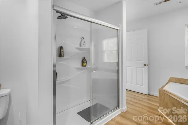 a bathroom with a shower and a glass door