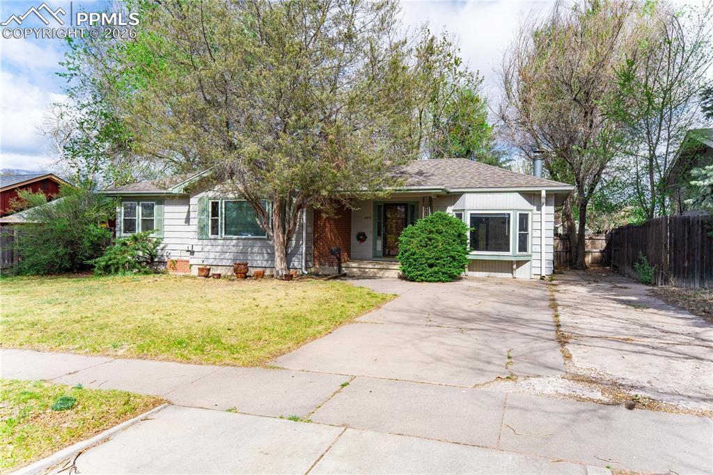 2818 Templeton Gap Road Colorado Springs, CO 80907 - Photo 25 of 27 a front view of a house with a yard and trees