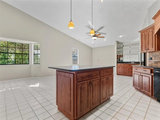 a kitchen with stainless steel appliances granite countertop a refrigerator and a stove