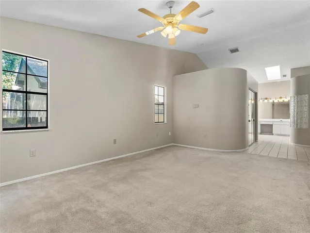 a bathroom with a glass shower door and a mirror