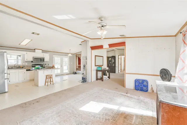 a view of kitchen with sink and refrigerator