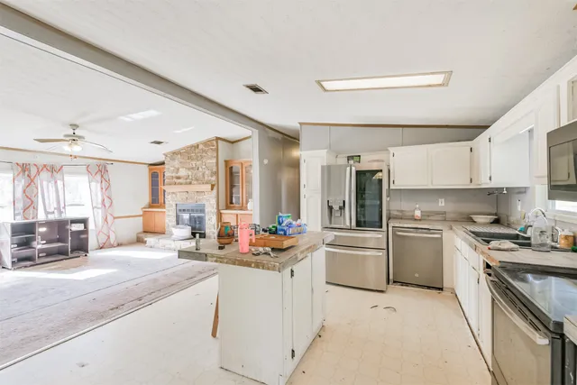 a kitchen with a sink stove and cabinets