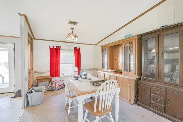 a dining room with furniture and window
