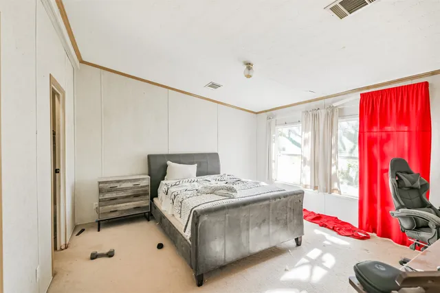 a bedroom with a bed and a window