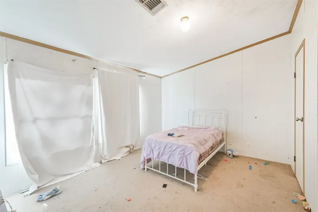 a bedroom with a bed and a mirror