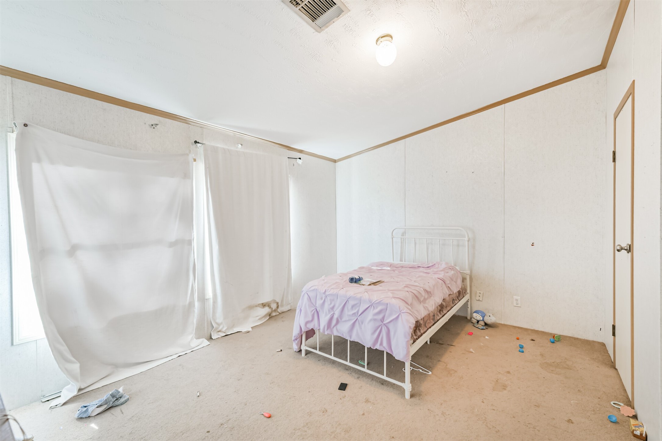 18 County Road 2236 Cleveland, TX 77327 - Photo 22 of 28 a bedroom with a bed and a mirror