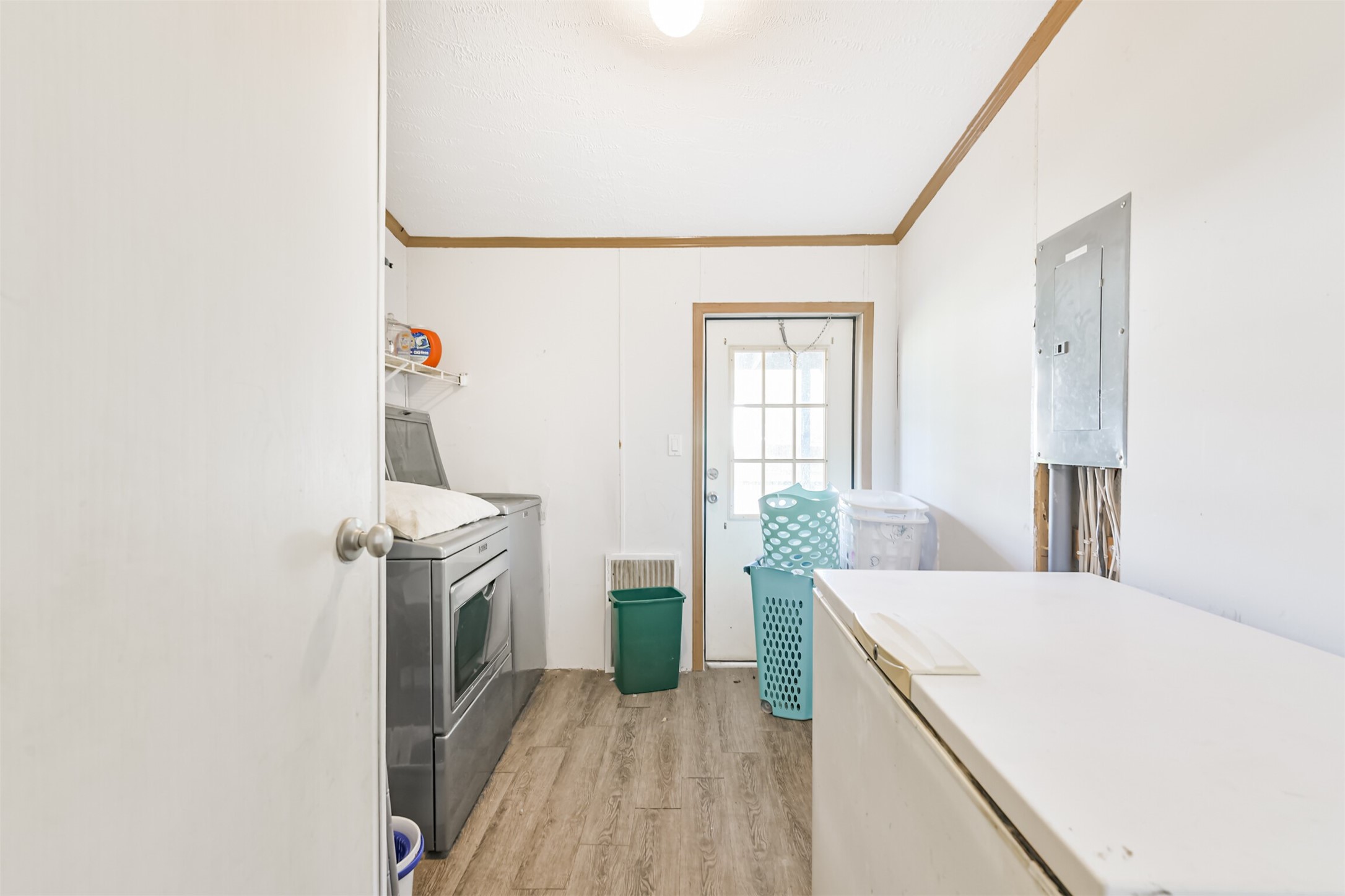 18 County Road 2236 Cleveland, TX 77327 - Photo 24 of 28 a view of a kitchen with fridge and wooden floor