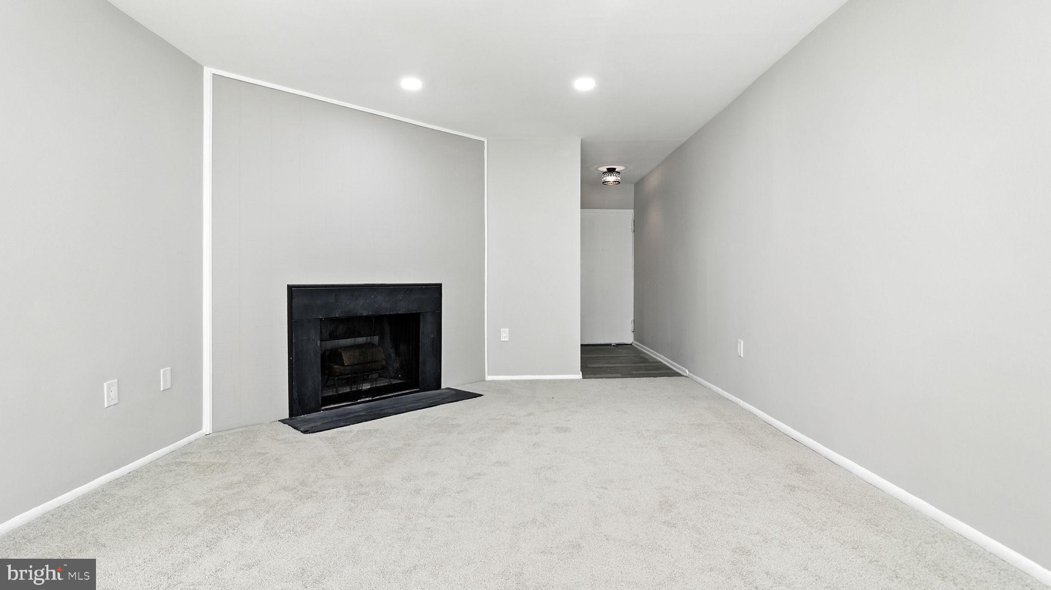 8693 Greenbelt Road, Unit 202 Greenbelt, MD 20770 - Photo 11 of 40 a view of an empty room with a fireplace