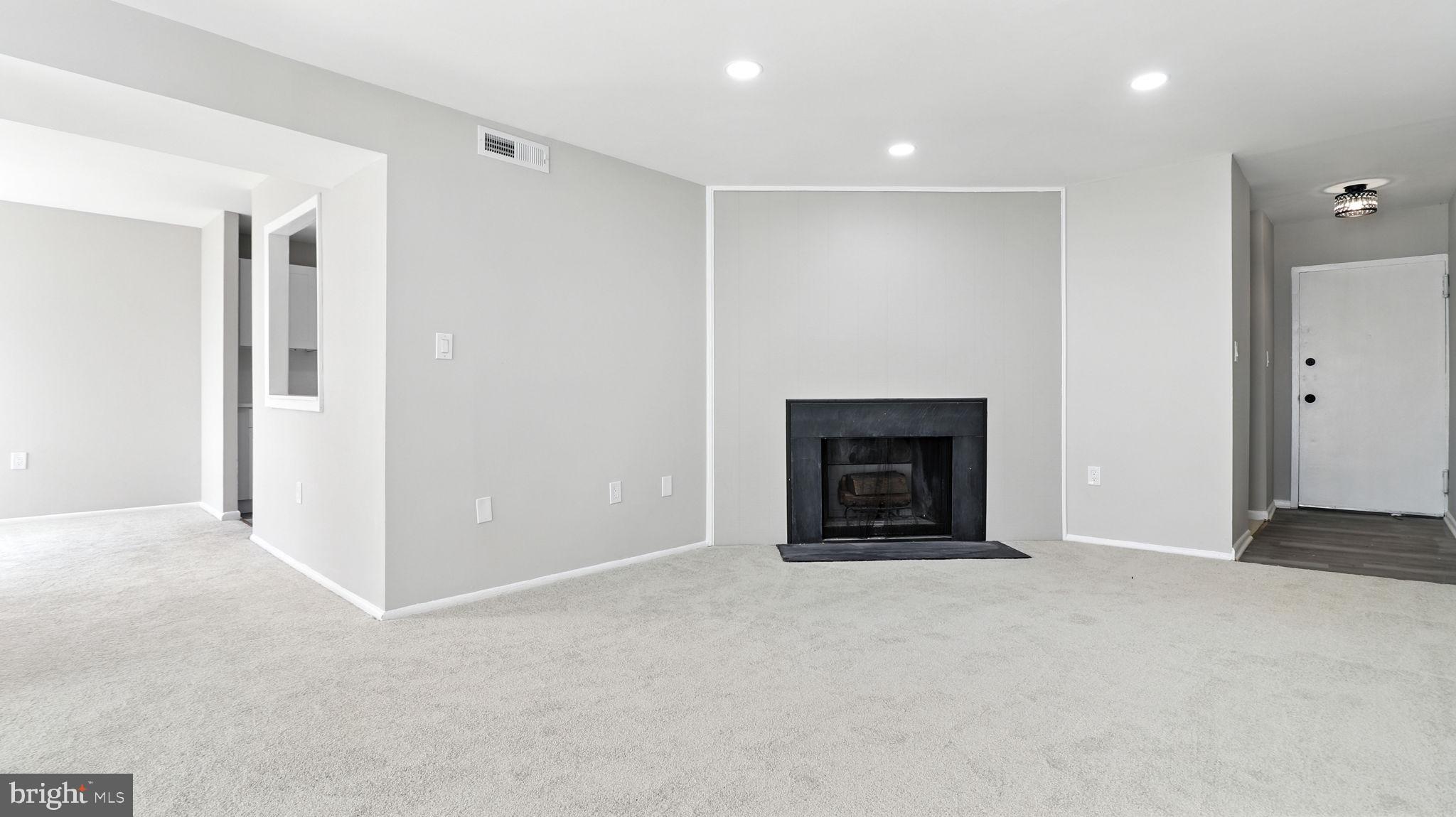 8693 Greenbelt Road, Unit 202 Greenbelt, MD 20770 - Photo 12 of 40 a view of an empty room with a fireplace