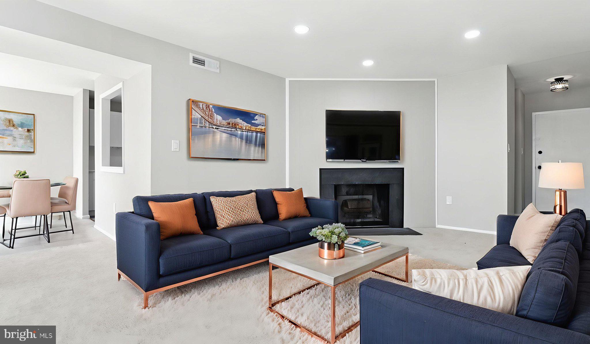 8693 Greenbelt Road, Unit 202 Greenbelt, MD 20770 - Photo 13 of 40 a living room with furniture and a flat screen tv