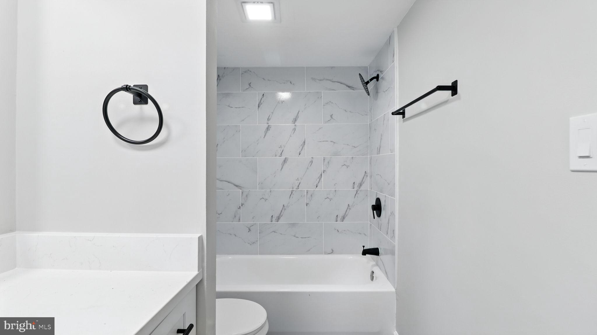 8693 Greenbelt Road, Unit 202 Greenbelt, MD 20770 - Photo 28 of 40 a bathroom with a bath tub and a shower