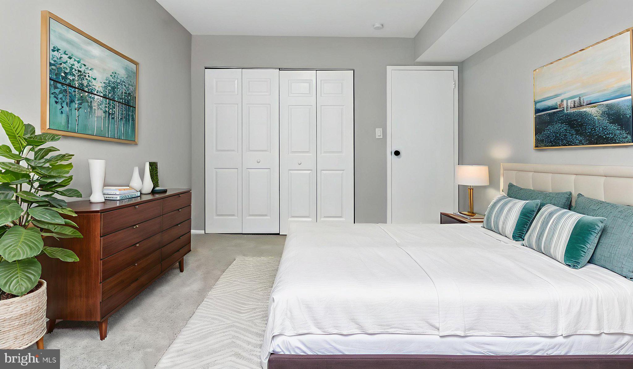 8693 Greenbelt Road, Unit 202 Greenbelt, MD 20770 - Photo 40 of 40 a spacious bedroom with a bed and a potted plant