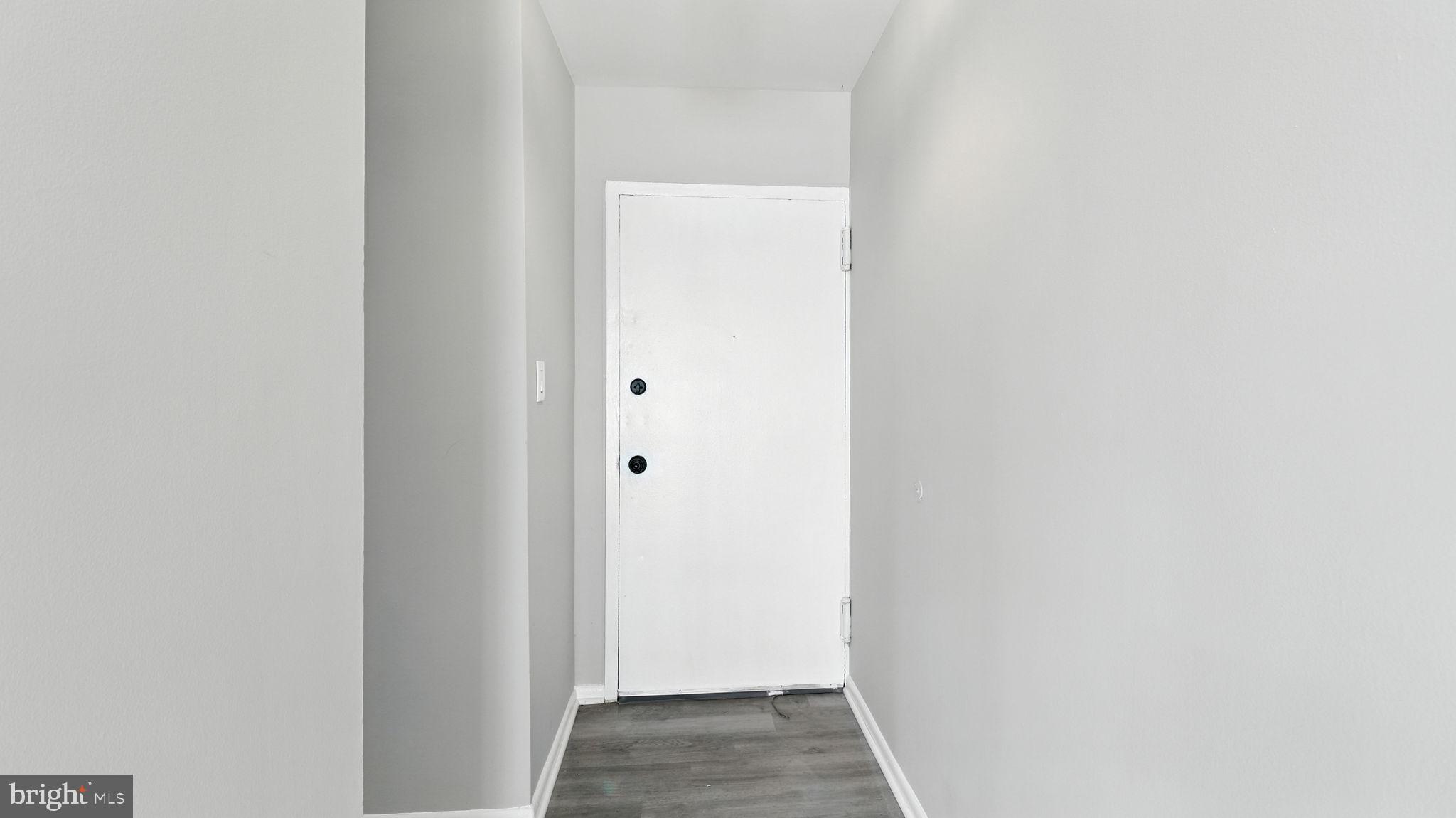 8693 Greenbelt Road, Unit 202 Greenbelt, MD 20770 - Photo 8 of 40 a view of a hallway with wooden floor