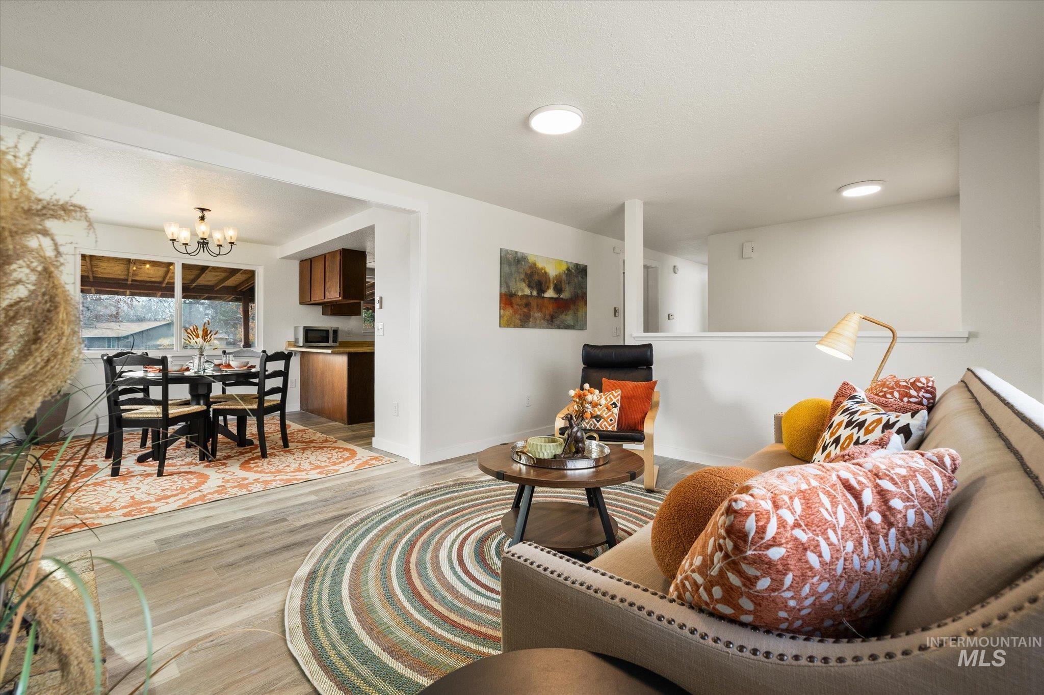 419 West Logan Street Caldwell, ID 83605 - Photo 11 of 50 Living area featuring a chandelier and light wood finished floors