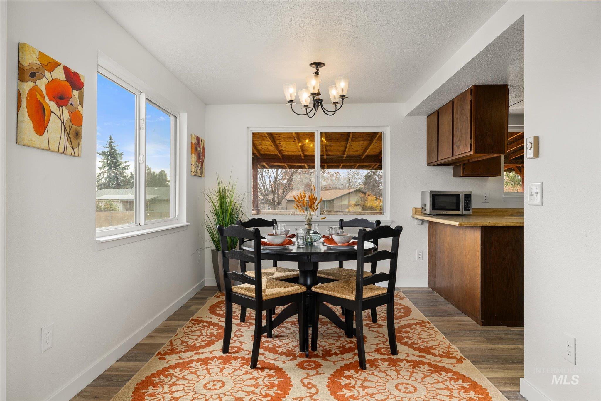 419 West Logan Street Caldwell, ID 83605 - Photo 12 of 50 Dining room featuring a chandelier and dark wood-style flooring