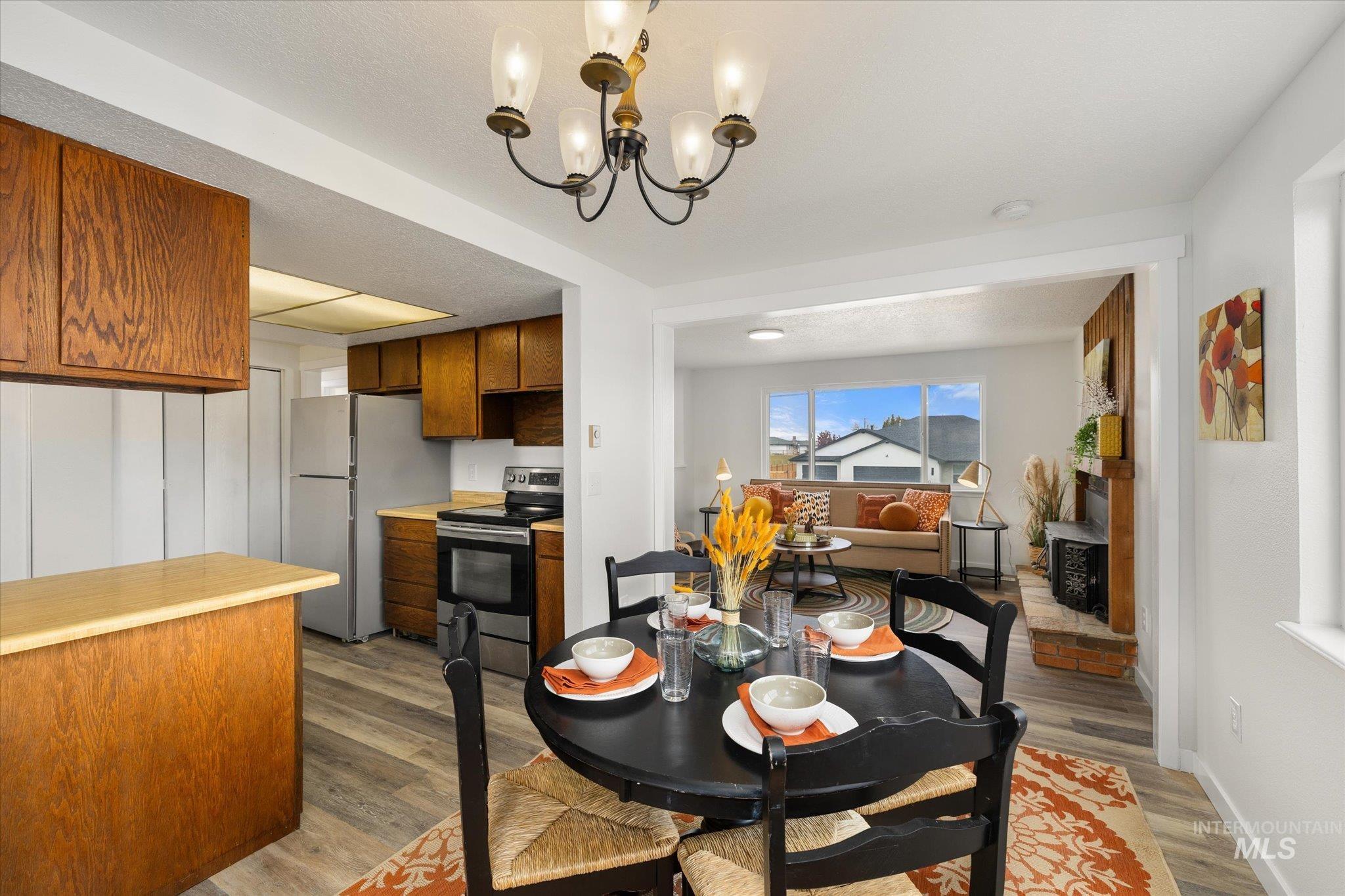 419 West Logan Street Caldwell, ID 83605 - Photo 14 of 50 Dining room featuring a chandelier and dark wood-type flooring