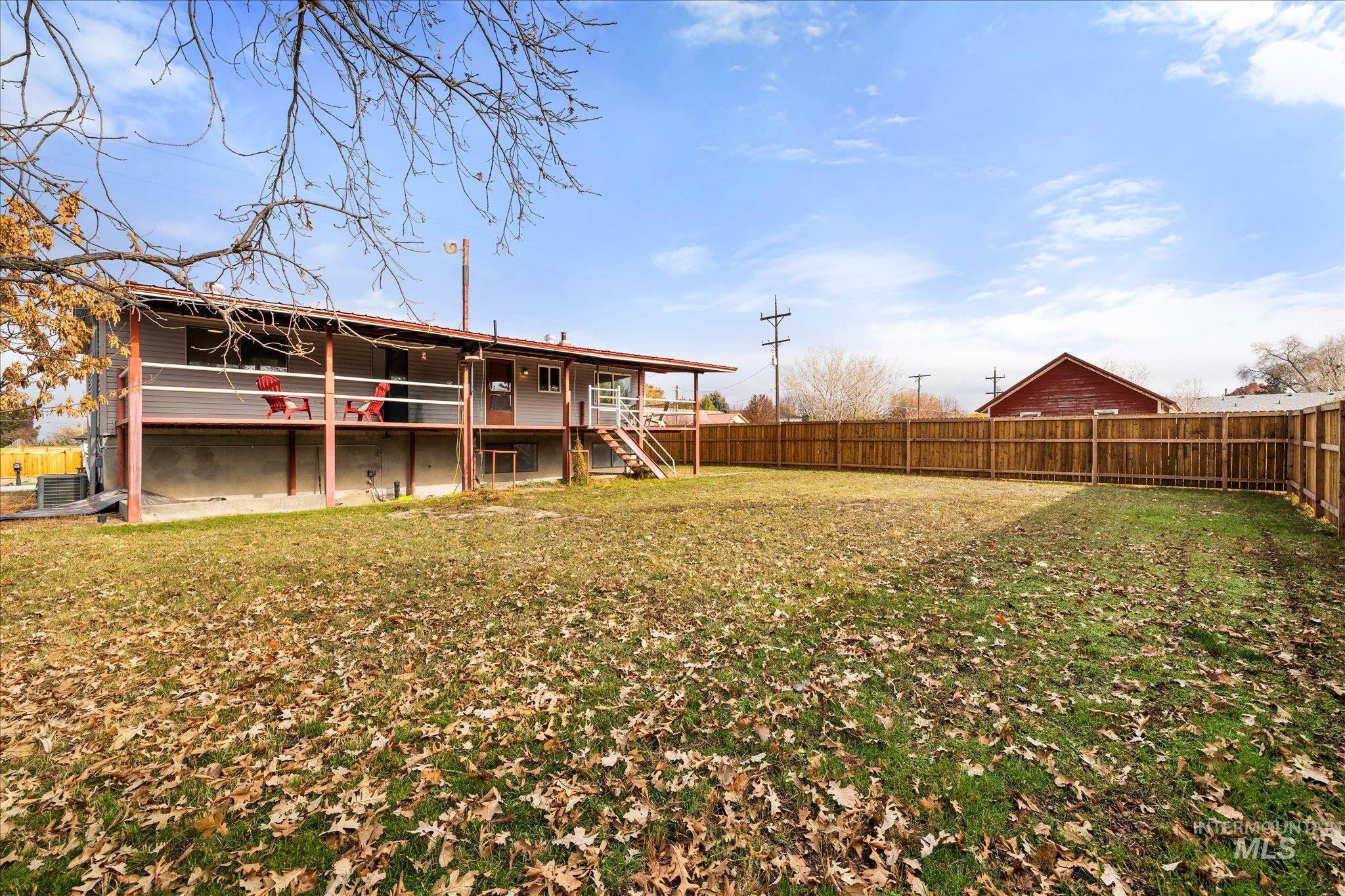 419 West Logan Street Caldwell, ID 83605 - Photo 2 of 50 Back of house featuring a deck and a fenced backyard