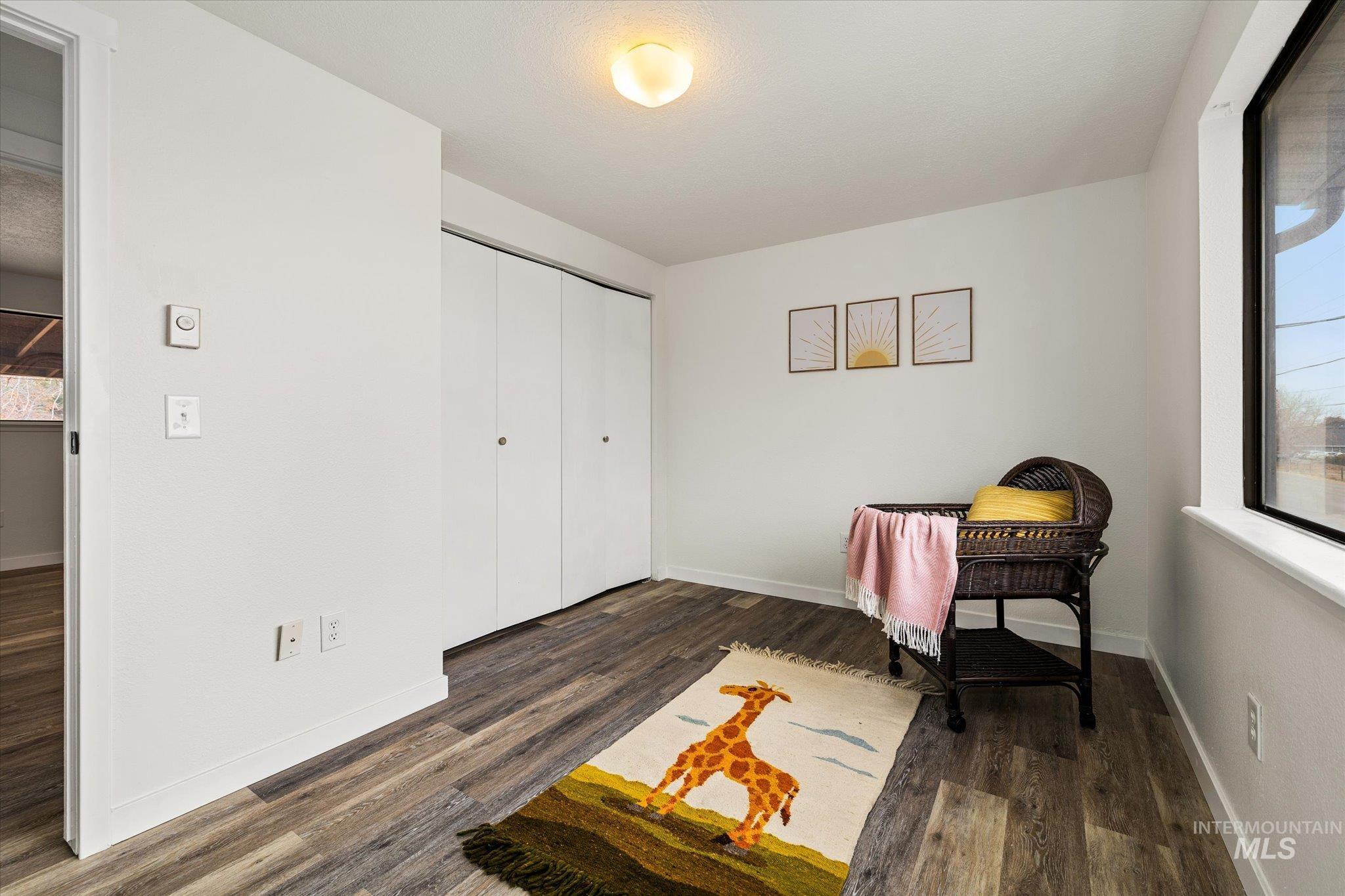 419 West Logan Street Caldwell, ID 83605 - Photo 28 of 50 Office space with baseboards and dark wood-style flooring