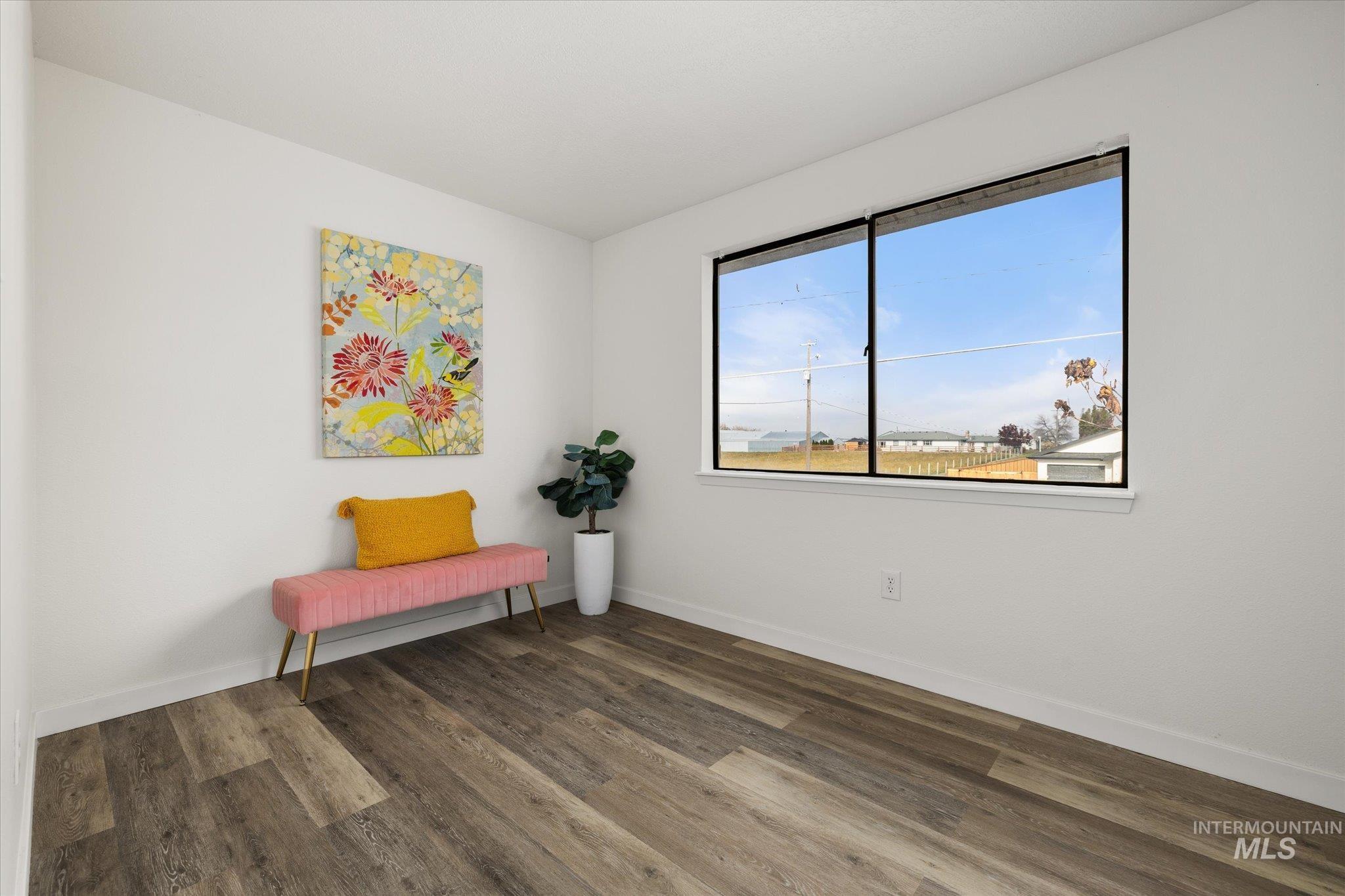 419 West Logan Street Caldwell, ID 83605 - Photo 29 of 50 Living area featuring dark wood finished floors and baseboards