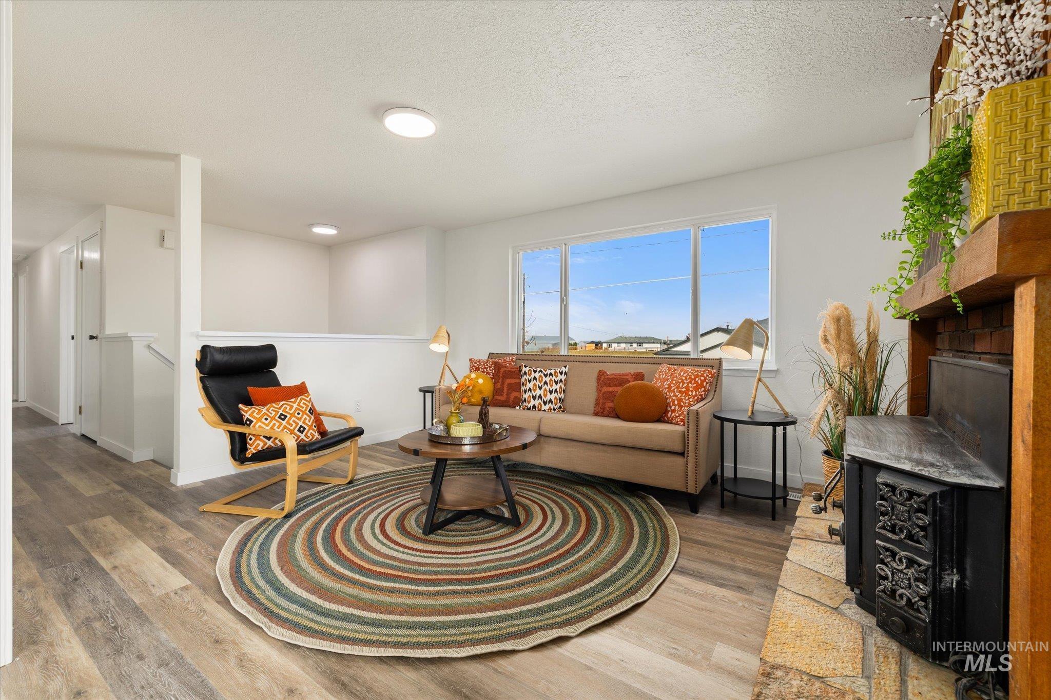 419 West Logan Street Caldwell, ID 83605 - Photo 7 of 50 Living room with wood finished floors and a textured ceiling