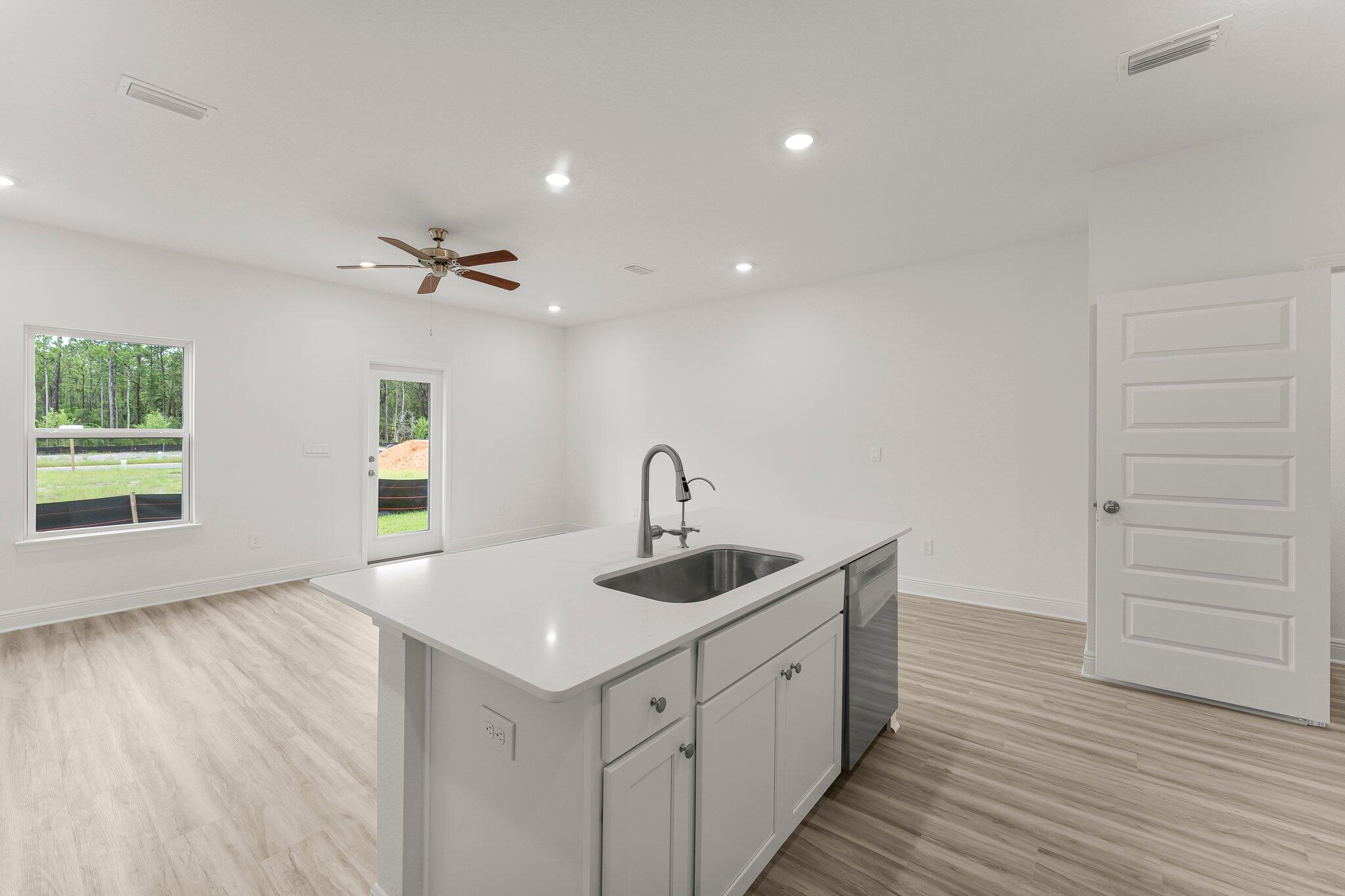 44 Hawk Street Santa Rosa Beach, FL 32459 - Photo 14 of 34 a kitchen with a sink and cabinets