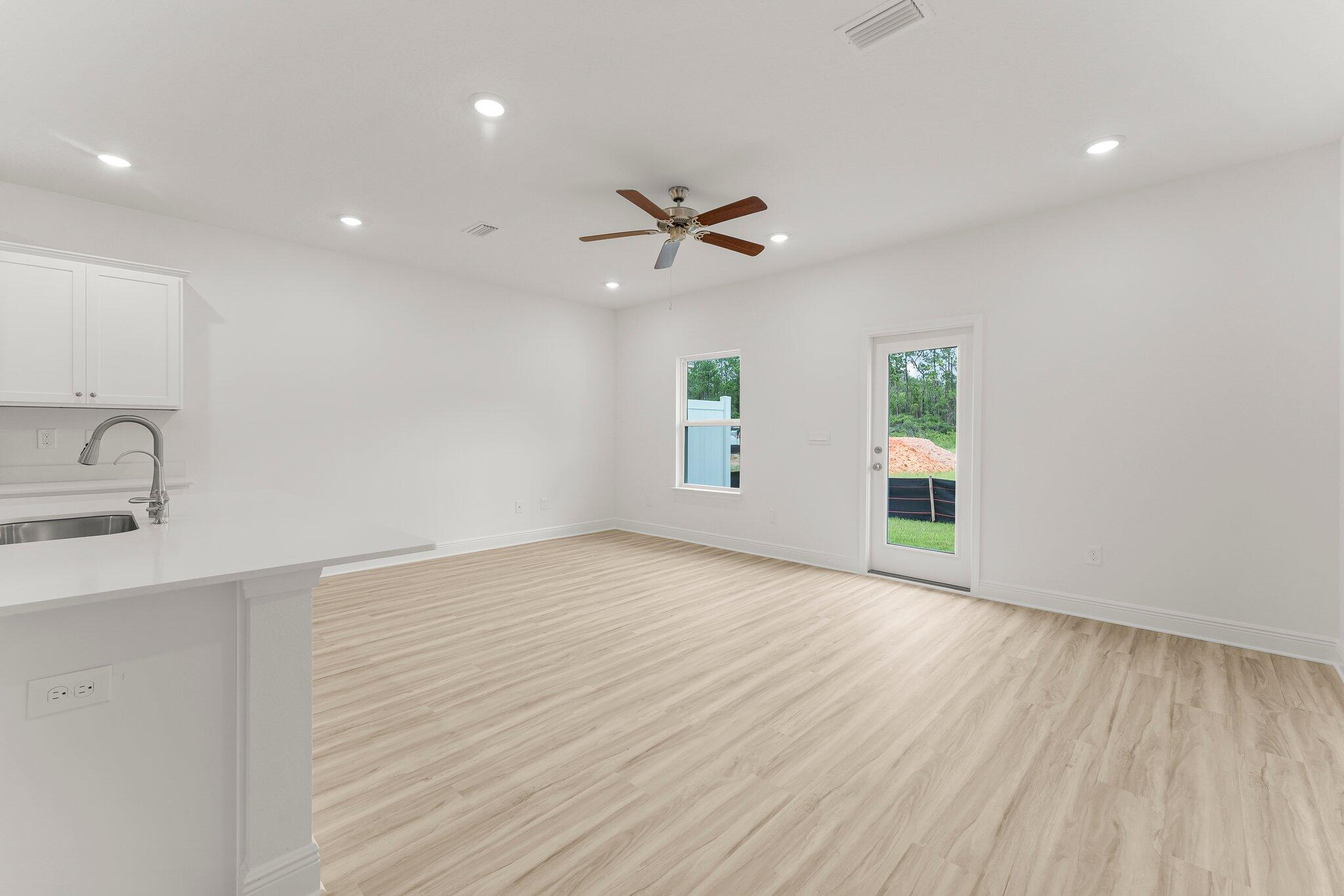 44 Hawk Street Santa Rosa Beach, FL 32459 - Photo 16 of 34 wooden floor in an empty room with a window