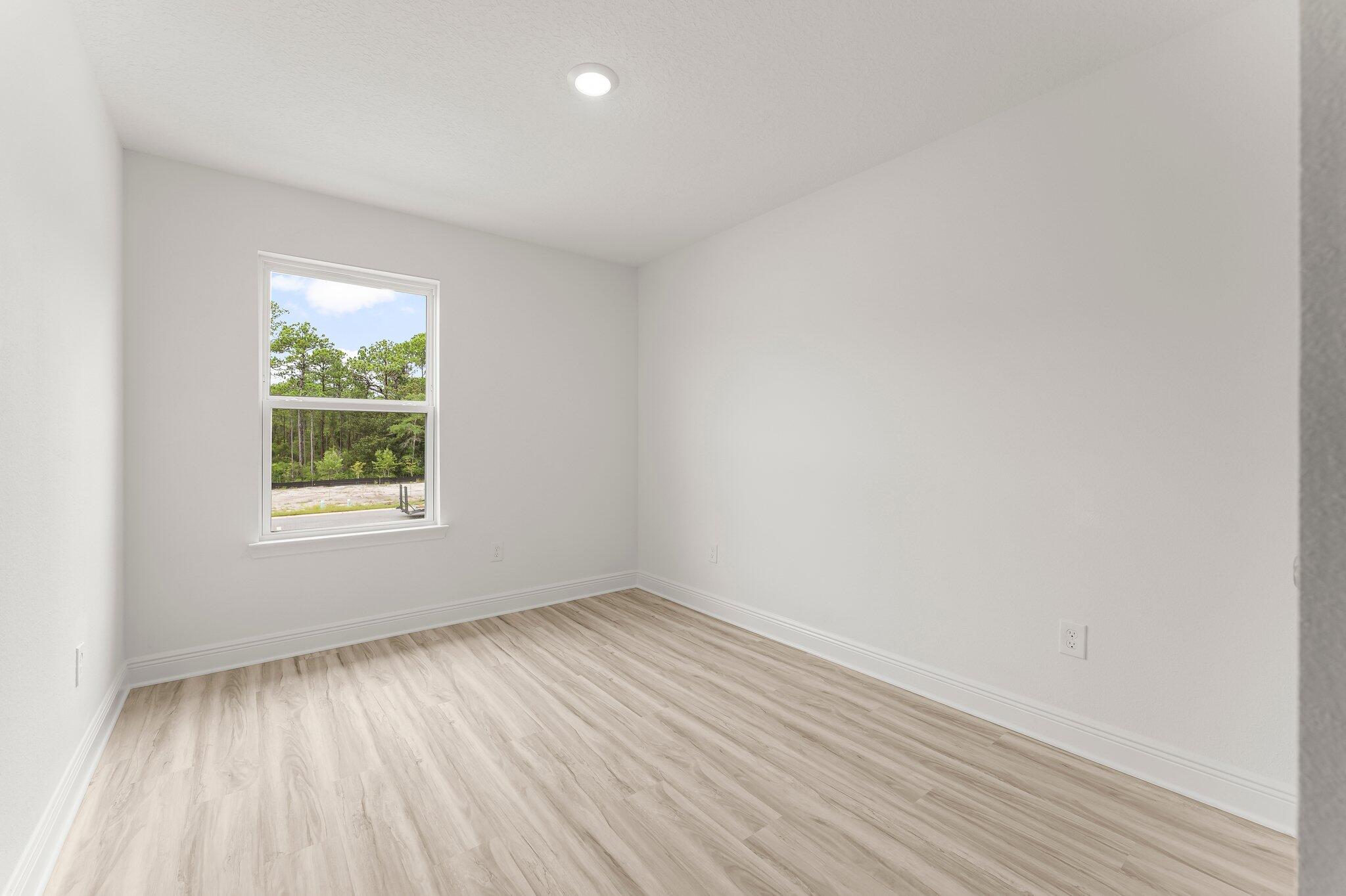 44 Hawk Street Santa Rosa Beach, FL 32459 - Photo 25 of 34 an empty room with wooden floor and windows