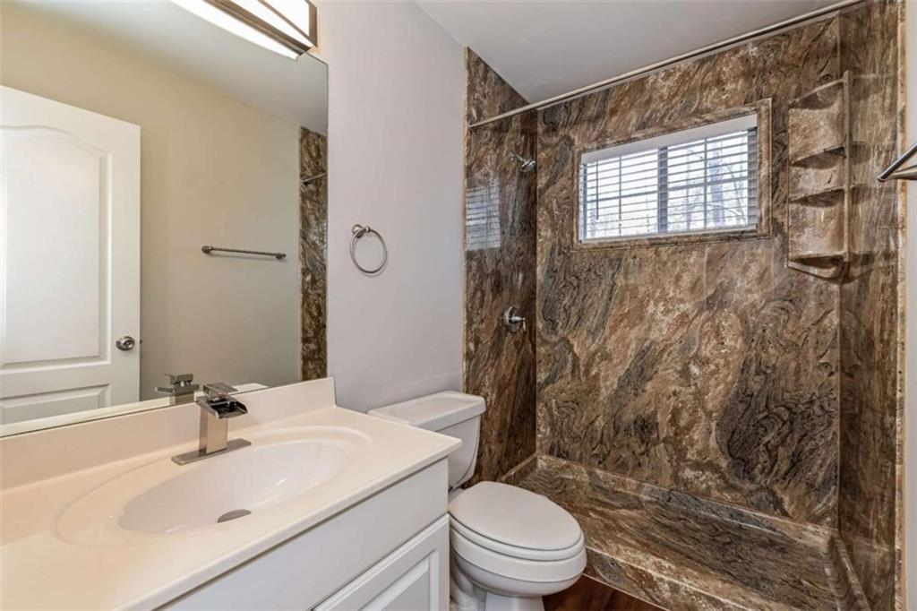 106 Emerald Lane Hampton, GA 30228 - Photo 19 of 19 a bathroom with a sink toilet and shower