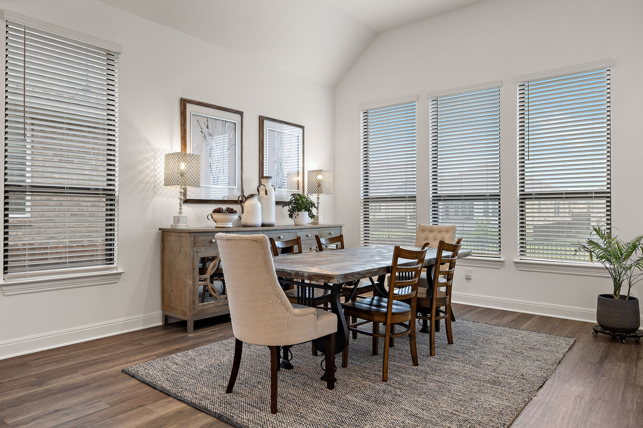 181 Constitution Way Kyle, TX 78640 - Photo 15 of 32 a view of a dining room with furniture and wooden floor