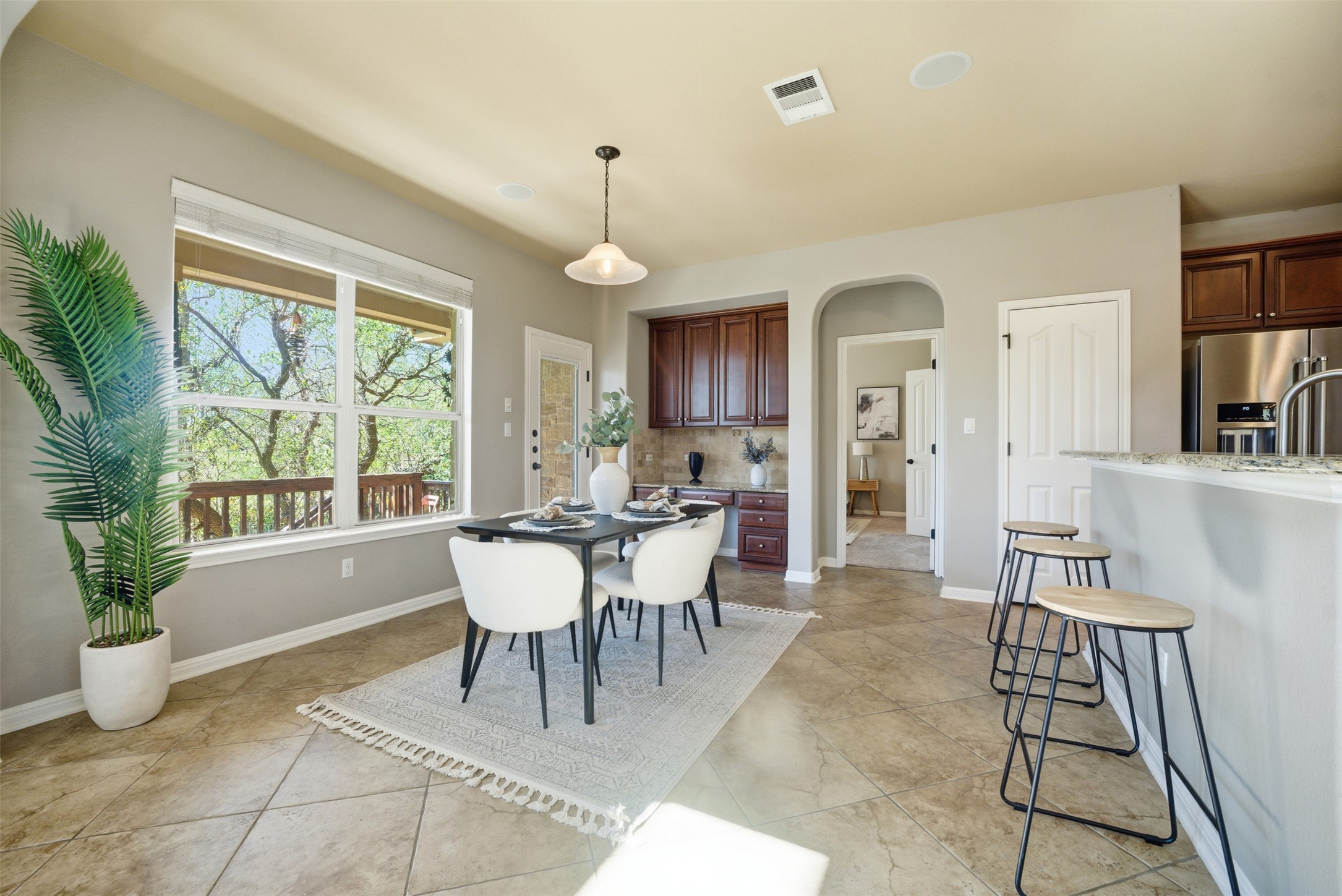 16100 Spillman Ranch Loop Austin, TX 78738 - Photo 14 of 39 a view of a dining room with furniture and a potted plant