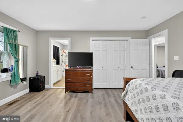 a bedroom with a bed and a television