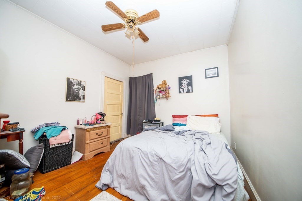 119 Lapham Street Fall River, MA 02721 - Photo 13 of 29 a bedroom with a bed and a chandelier