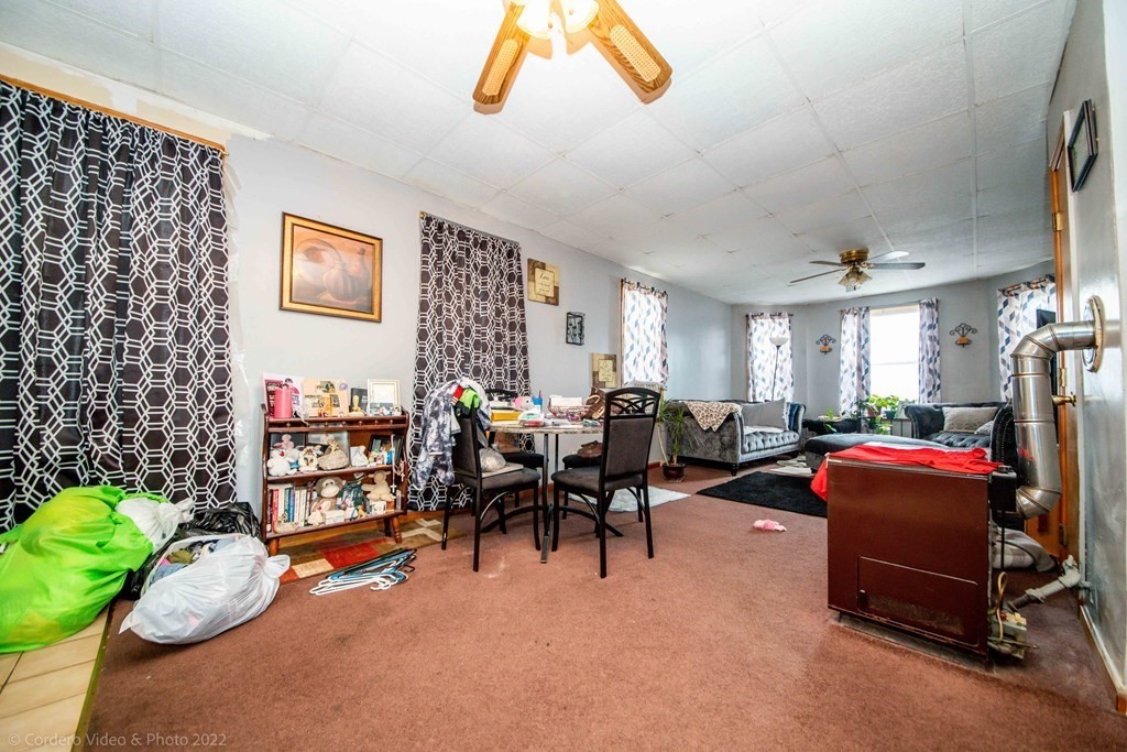 119 Lapham Street Fall River, MA 02721 - Photo 15 of 29 a living room with furniture a rug and gym equipment