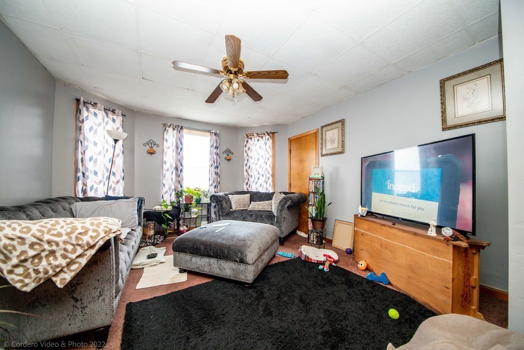 119 Lapham Street Fall River, MA 02721 - Photo 18 of 29 a bedroom with a bed and a chandelier