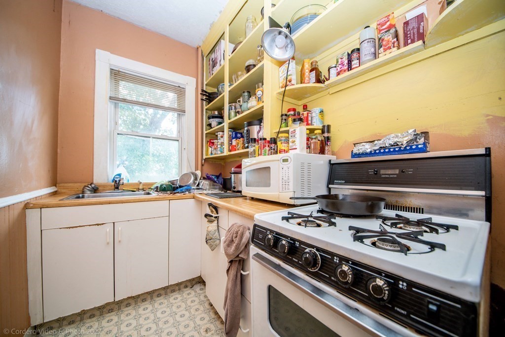 119 Lapham Street Fall River, MA 02721 - Photo 21 of 29 a kitchen with a stove and a sink