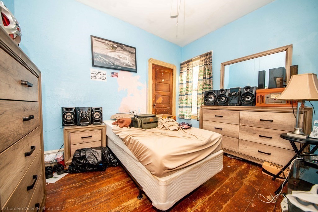 119 Lapham Street Fall River, MA 02721 - Photo 5 of 29 a bedroom with a bed and a lamp on dresser