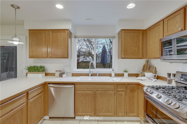 a kitchen with a sink stove top oven and cabinets