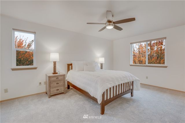 a spacious bedroom with a bed and a chandelier
