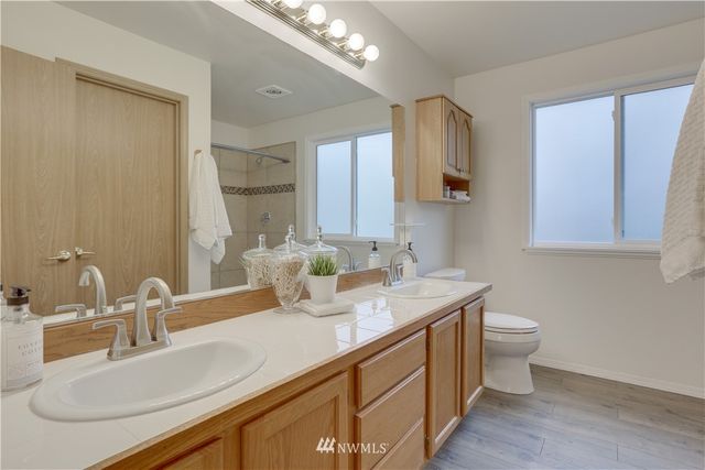 a bathroom with a sink double vanity and a toilet