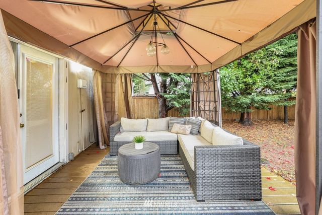 a outdoor space with the couches and dining table with the garden view