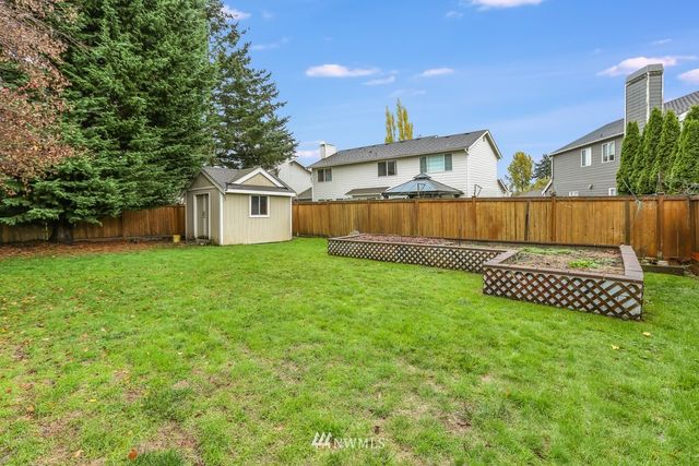 a view of a house with a yard and a porch