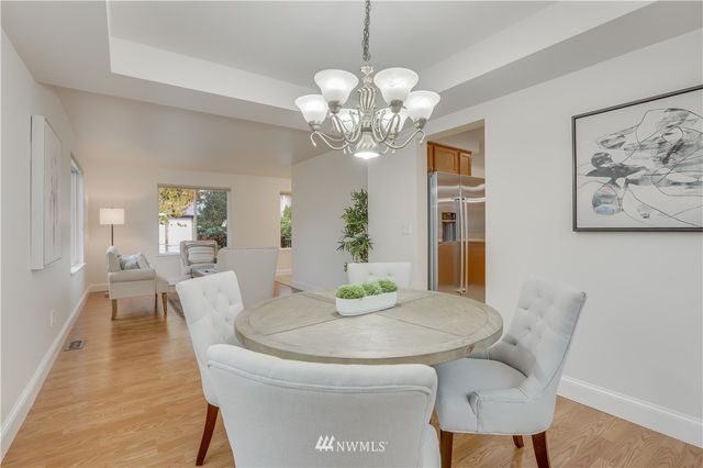 a dining room with furniture and chandelier