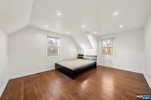a living room with hard wood floors and a window